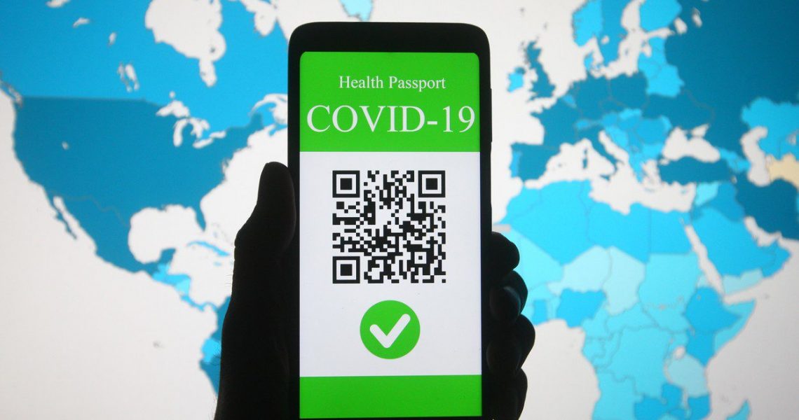 March 28, 2021, Ukraine: In this photo illustration, a symbolic COVID-19 health passport seen on a smartphone in front of the World Health Organization (WHO) global map displaying COVID-19 coronavirus cases. .On March 17 the European Commission presented a proposal to create a Digital Green Certificate to facilitate the safe free movement of the EU citizens during the  COVID-19  pandemic.,Image: 601817056, License: Rights-managed, Restrictions: , Model Release: no, Credit line: Profimedia